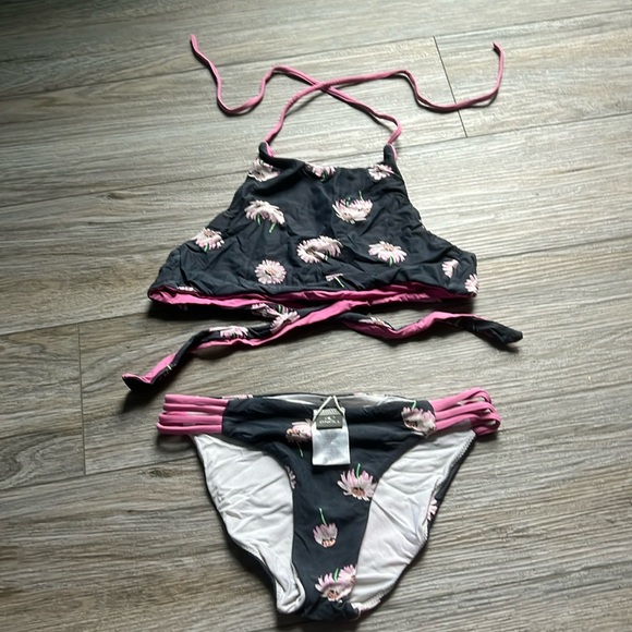 O’Neill kids bathing suit look worn out but that is just the original color.